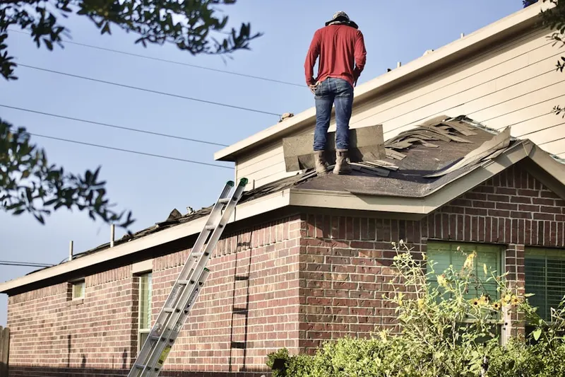 Professional roofer working on a residential roof in Liberty Square